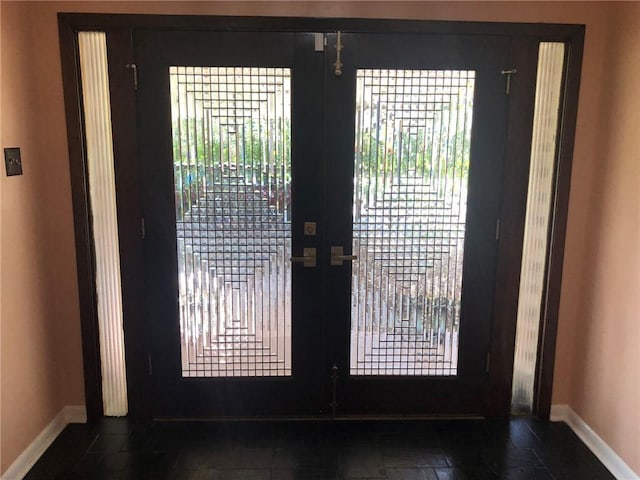 doorway to outside with baseboards and french doors