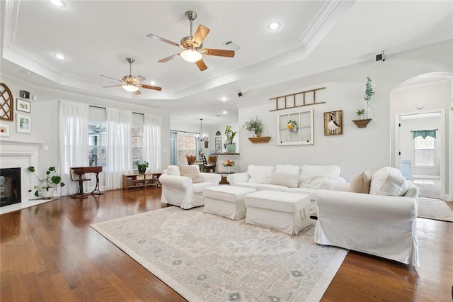 155 Maud Olive Dr, Belle Chasse, LA 70037 - living area with arched walkways, ornamental molding, a ceiling fan, wood finished floors, and a raised ceiling