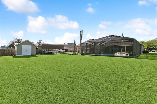 155 Maud Olive Dr, Belle Chasse, LA 70037 - view of yard featuring glass enclosure, fence, an outbuilding, and a storage unit