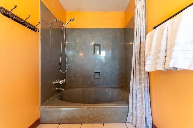 full bath with tile patterned floors, shower / bathtub combination, and a textured ceiling