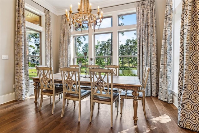 dining area featuring baseboards, an inviting chandelier, ornamental molding, and wood finished floors
