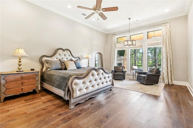 bedroom with baseboards, ornamental molding, recessed lighting, visible vents, and wood finished floors