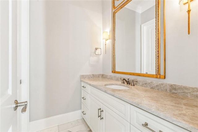 bathroom featuring marble finish floor, baseboards, and vanity