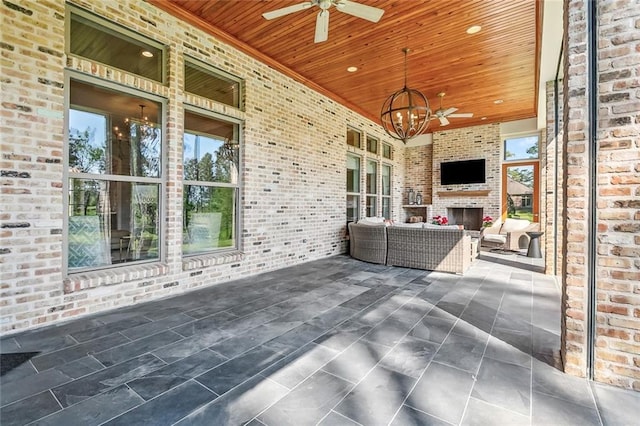 view of patio / terrace featuring an outdoor living space with a fireplace and ceiling fan