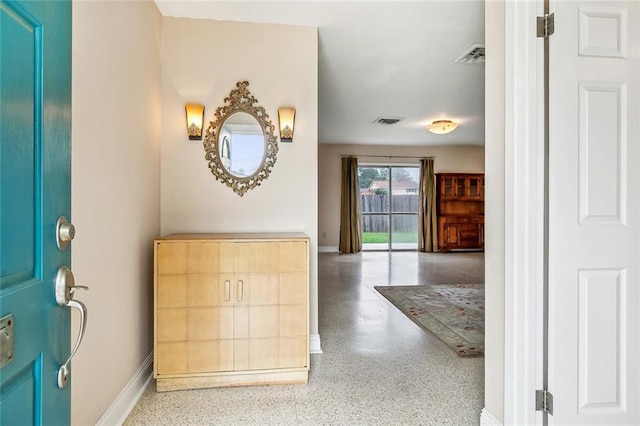 6505 Carmen St, Metairie, LA 70003 - foyer entrance featuring visible vents, baseboards, and speckled floor