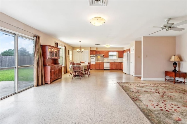 6505 Carmen St, Metairie, LA 70003 - dining area with visible vents, ceiling fan with notable chandelier, and light speckled floor