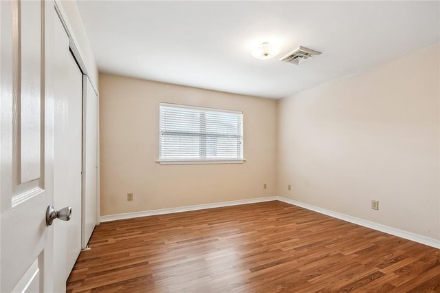6505 Carmen St, Metairie, LA 70003 - unfurnished bedroom featuring visible vents, baseboards, a closet, and wood finished floors