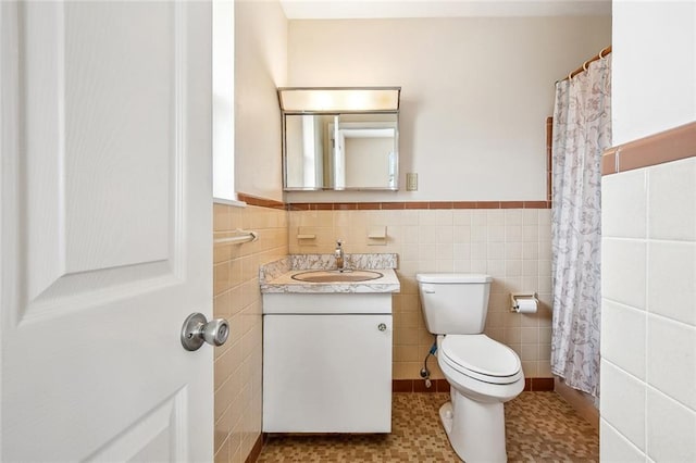 6505 Carmen St, Metairie, LA 70003 - full bathroom featuring toilet, vanity, tile walls, and a wainscoted wall