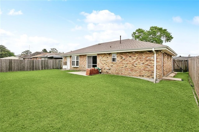6505 Carmen St, Metairie, LA 70003 - rear view of property featuring a shingled roof, a lawn, a fenced backyard, and brick siding