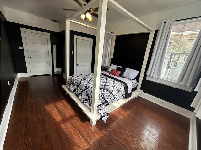 bedroom with wood finished floors, baseboards, and ceiling fan