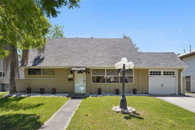 10012 Joel Ave, River Ridge, LA 70123 - ranch-style house featuring roof with shingles, board and batten siding, an attached garage, and a front lawn