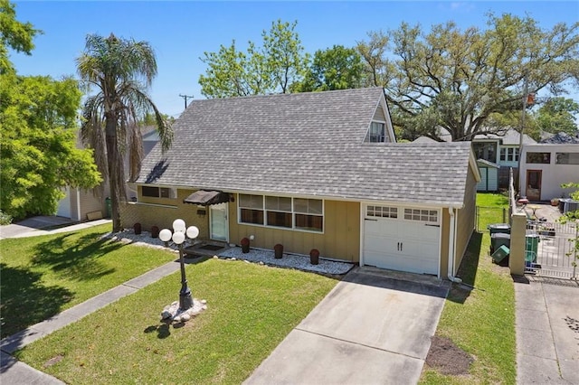 10012 Joel Ave, River Ridge, LA 70123 - view of front facade with a shingled roof, a garage, board and batten siding, a front yard, and driveway