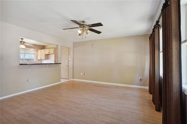 10012 Joel Ave, River Ridge, LA 70123 - unfurnished living room with a ceiling fan, baseboards, and light wood finished floors