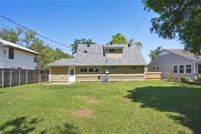 10012 Joel Ave, River Ridge, LA 70123 - back of house with a fenced backyard, a yard, and central AC unit