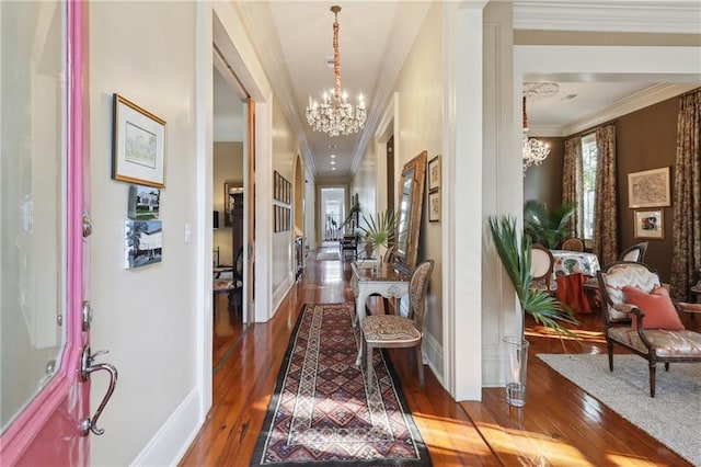 3611 Carondelet St, New Orleans, LA 70115 - entrance foyer featuring an inviting chandelier, ornamental molding, baseboards, and hardwood / wood-style flooring