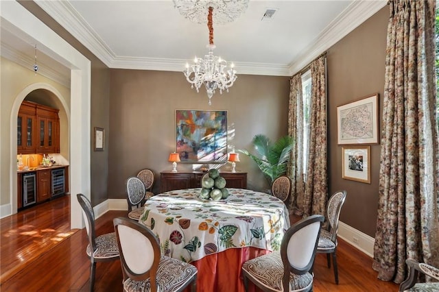 3611 Carondelet St, New Orleans, LA 70115 - dining room featuring baseboards, wine cooler, and wood finished floors