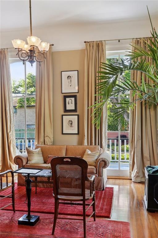 3611 Carondelet St, New Orleans, LA 70115 - sitting room featuring wood finished floors and a chandelier