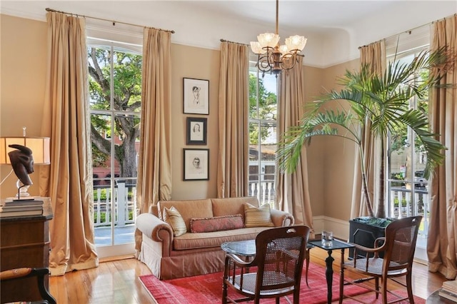 3611 Carondelet St, New Orleans, LA 70115 - sitting room featuring french doors, a chandelier, and wood finished floors