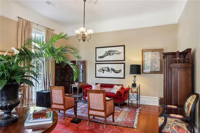 3611 Carondelet St, New Orleans, LA 70115 - interior space featuring visible vents, baseboards, wood finished floors, and a notable chandelier