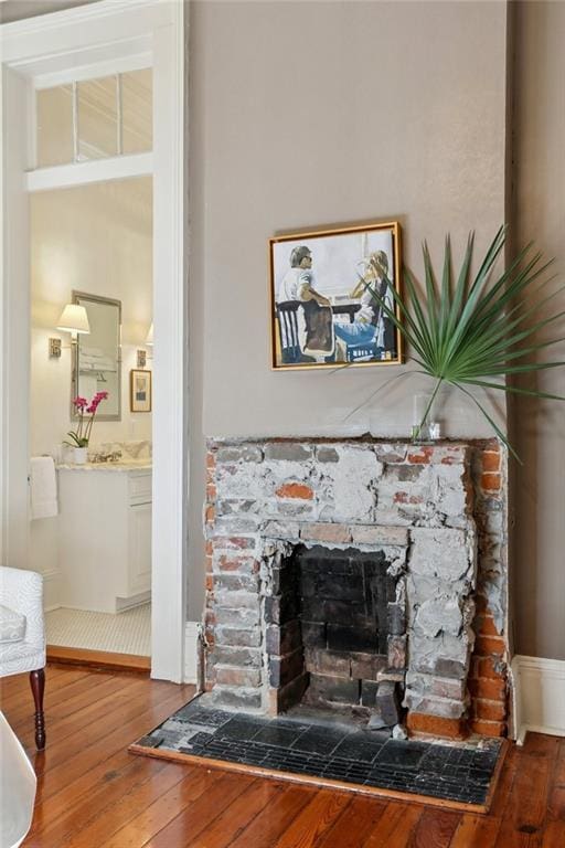 3611 Carondelet St, New Orleans, LA 70115 - details with a stone fireplace and wood finished floors