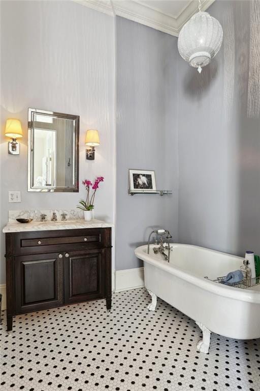 3611 Carondelet St, New Orleans, LA 70115 - bathroom featuring vanity, ornamental molding, a freestanding tub, baseboards, and tile patterned floors