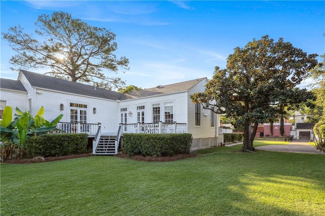 3611 Carondelet St, New Orleans, LA 70115 - back of house featuring a yard and a wooden deck