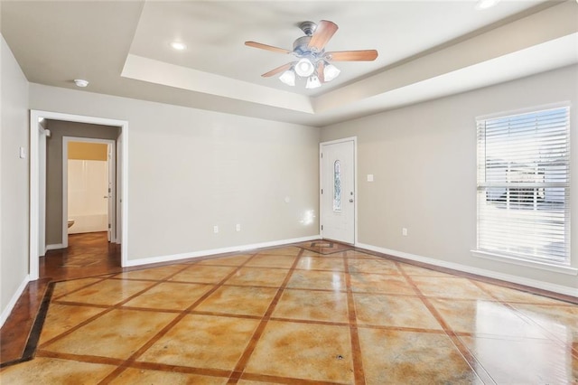 48351 Woodhaven Rd, Tickfaw, LA 70466 - spare room with a raised ceiling, baseboards, a ceiling fan, and recessed lighting