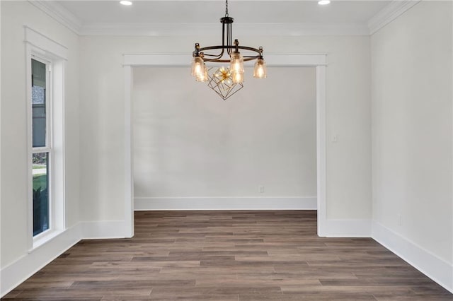 unfurnished dining area with a notable chandelier, baseboards, ornamental molding, and wood finished floors