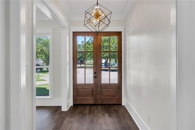 doorway to outside featuring dark wood finished floors, ornamental molding, a chandelier, french doors, and baseboards