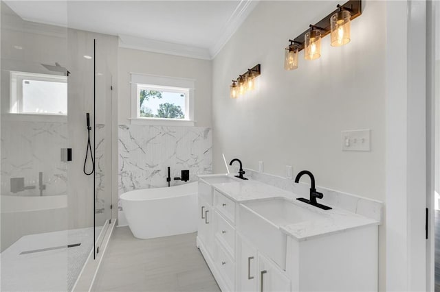 bathroom with a freestanding bath, a sink, a marble finish shower, and crown molding