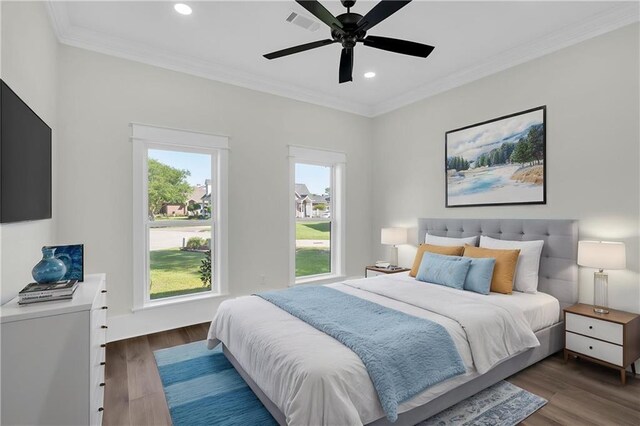 bedroom featuring wood finished floors, ornamental molding, and recessed lighting