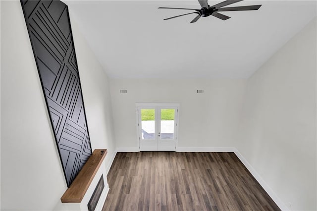 unfurnished living room with visible vents, baseboards, a ceiling fan, dark wood-style floors, and french doors