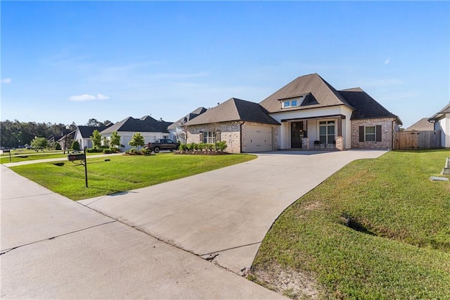 view of front of house featuring a front yard, an attached garage, fence, and concrete driveway