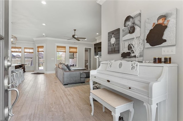 living area with ornamental molding, ceiling fan, recessed lighting, and wood finished floors
