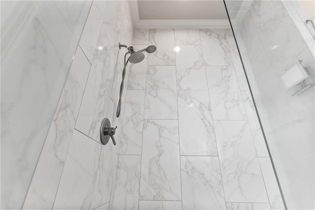 interior details featuring a tile shower