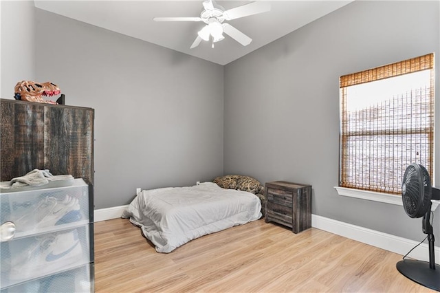 bedroom with wood finished floors, ceiling fan, and baseboards