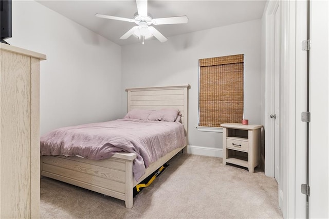 bedroom with baseboards, light colored carpet, and a ceiling fan