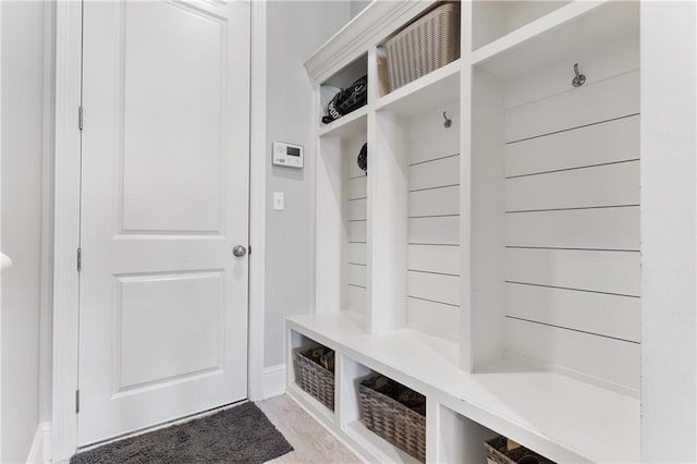 mudroom featuring light wood-type flooring and baseboards