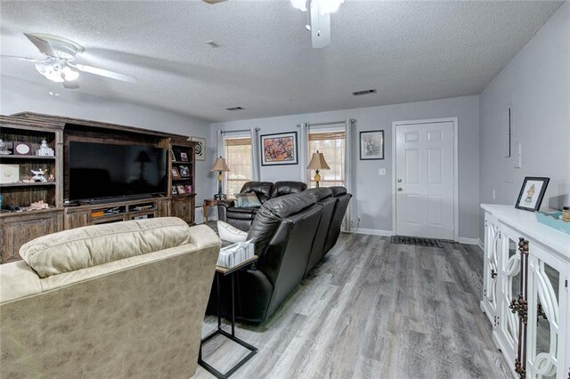 232 Chateau Dr, Slidell, LA 70460 - living area with ceiling fan, light wood finished floors, and a textured ceiling