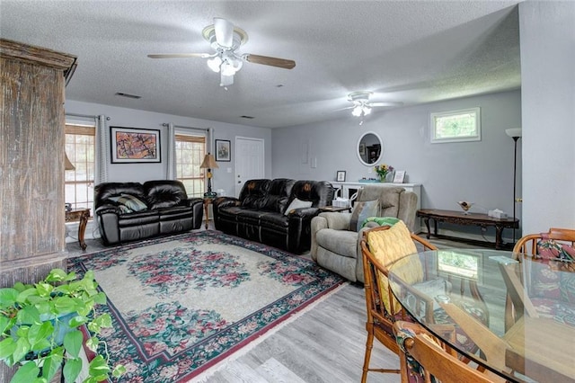 232 Chateau Dr, Slidell, LA 70460 - living area featuring ceiling fan, a textured ceiling, and wood finished floors