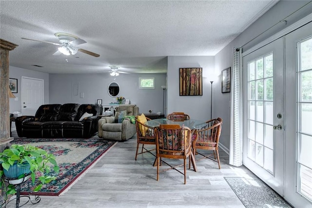 232 Chateau Dr, Slidell, LA 70460 - dining room with french doors, a textured ceiling, light wood finished floors, and plenty of natural light