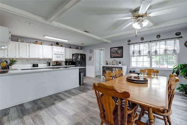 232 Chateau Dr, Slidell, LA 70460 - dining room with ceiling fan, a textured ceiling, and light wood-style flooring