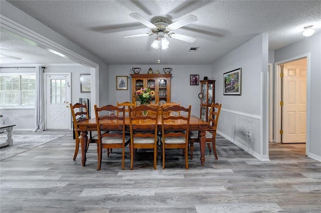 232 Chateau Dr, Slidell, LA 70460 - dining space with a textured ceiling, wood finished floors, and a ceiling fan