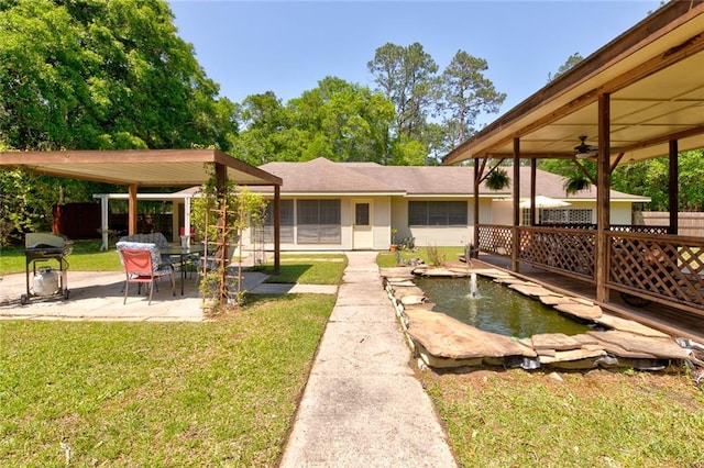 232 Chateau Dr, Slidell, LA 70460 - view of yard featuring a patio area, a ceiling fan, and a garden pond