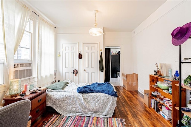 8632 Apple St, New Orleans, LA 70118 - bedroom featuring dark wood-style flooring and multiple closets