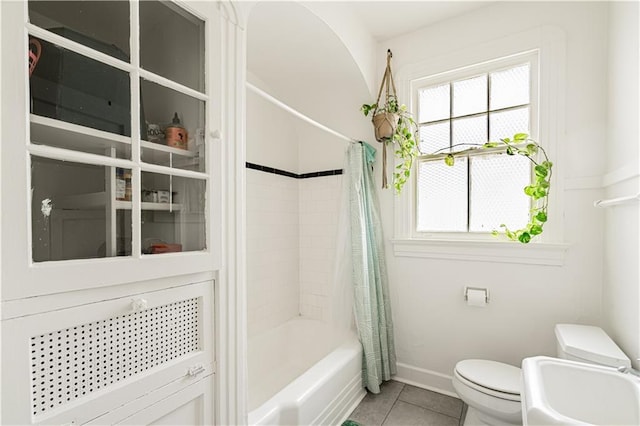 8632 Apple St, New Orleans, LA 70118 - full bath featuring shower / tub combo with curtain, tile patterned floors, a healthy amount of sunlight, and toilet