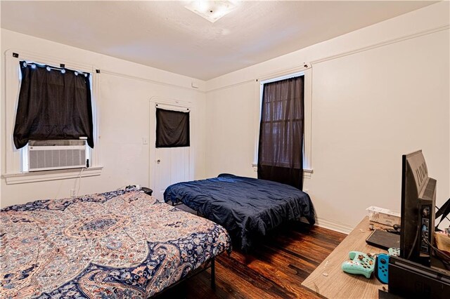8632 Apple St, New Orleans, LA 70118 - bedroom featuring baseboards, wood finished floors, and cooling unit