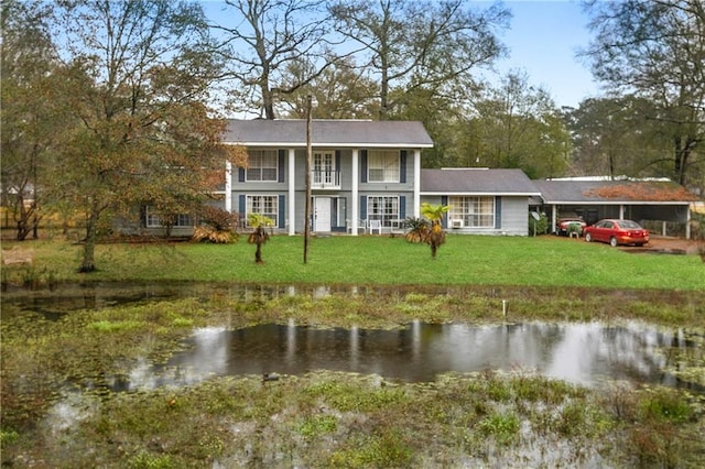 1805 13th Ave, Franklinton, LA 70438 - back of house featuring a water view, a detached carport, and a lawn