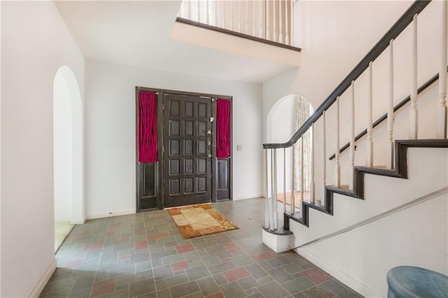 1805 13th Ave, Franklinton, LA 70438 - foyer with stairs, arched walkways, a towering ceiling, and baseboards