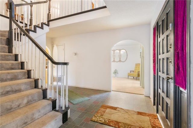 1805 13th Ave, Franklinton, LA 70438 - foyer with arched walkways, stairway, and baseboards